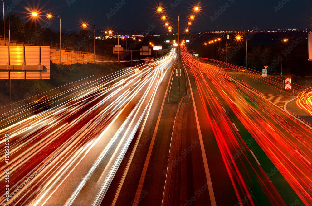 Car lights on the night highway