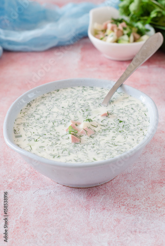Okroshka. Summer light cold yogurt soup with cucumber, radish, eggs and dill on a table. A traditional dish of Russian and Ukrainian cuisine. Selective focus