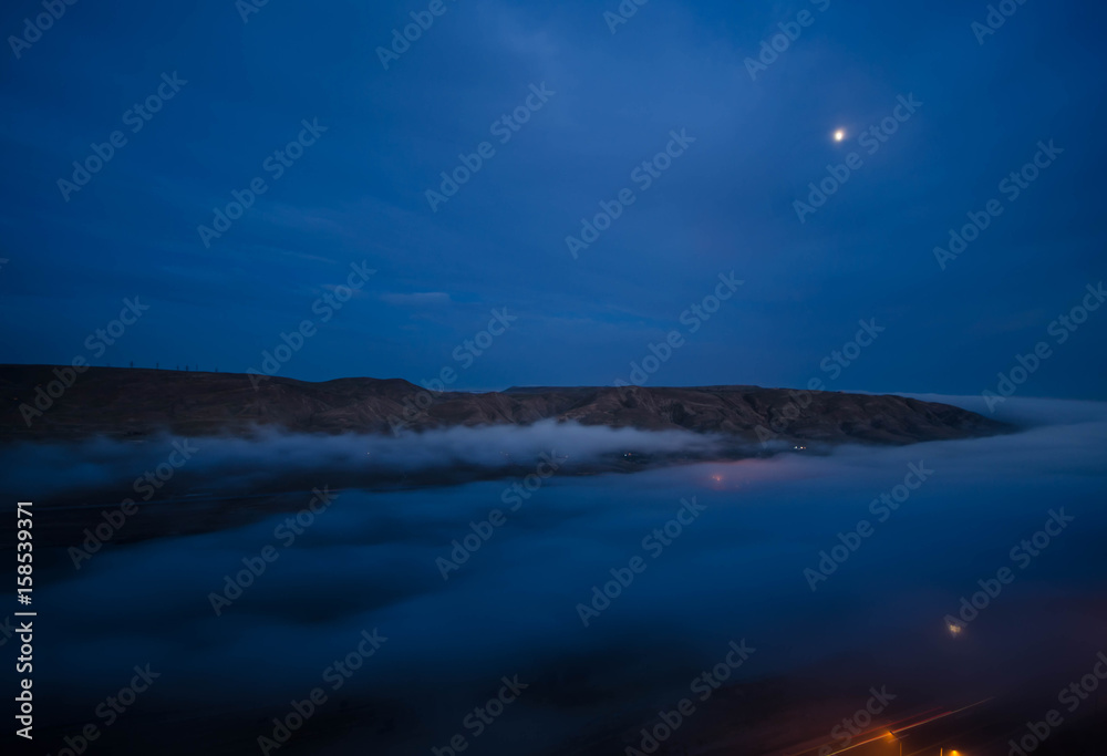 fog in the morning with mountain and moon at Baku, Azerbaijan