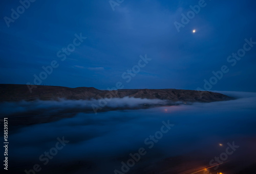 fog in the morning with mountain and moon at Baku, Azerbaijan © zef art