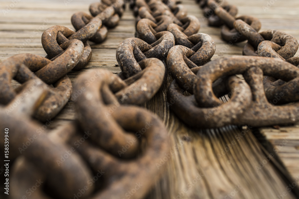 Ships anchor chain on a wooden pier in the harbor. Sardinia, Italy Ships anchor chain on a wooden pier in the harbor. Sardinia, Italy