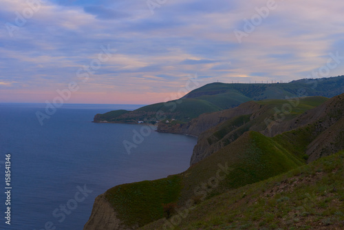 Fantastic ocean landscape in sunset or sunrise time in summer with pink sky. Travel concept for Crimea. Hiking ways. Start of adventure time on to coast