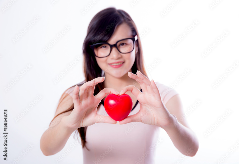 Young asian woman show heart hand sign on white background. Young asian woman show heart hand sign on white background.