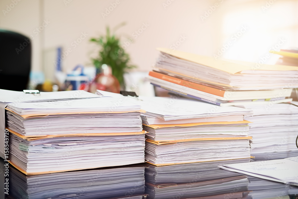 Close up Pile of unfinished business documents on office desk, Stack of business paper.Select focus. Close up Pile of unfinished business documents on office desk, Stack of business paper.Select focus.