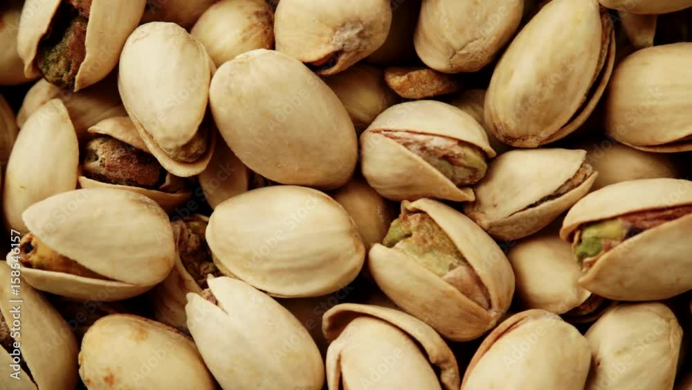 Food background. Roasted pistachio nuts seed with shell close up. Dieting concept. Dolly slider shot 4K ProRes HQ codec Food background. Roasted pistachio nuts seed with shell close up. Dieting concept. Dolly slider shot 4K ProRes HQ codec