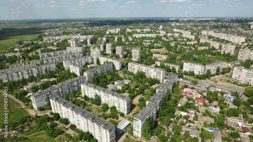 Marvelous shot of Kherson city in  Ukraine with multistoreyed apartment blocks, streets, cars, and green parks, in a sunny day in spring. The cityscape and skyscape look great and gorgeous. photo