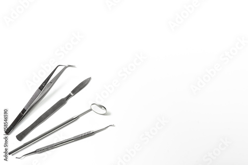 teeth care with dentist instruments in doctor's office white background top view mock-up