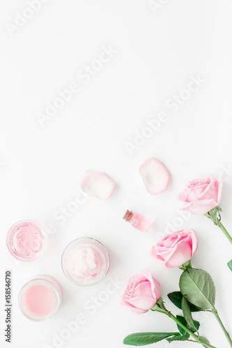 homemade spa with rose cosmetic set, cream, salt and oil on white background top view mock-up © 9dreamstudio