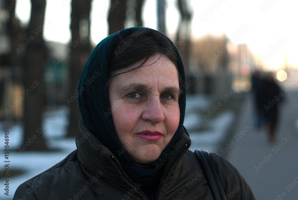 Old woman alone in a scarf portrait. Old woman alone in a scarf portrait.