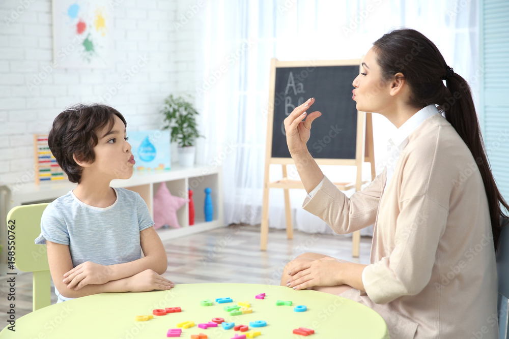 Young woman teacher and little boy on private lesson Young woman teacher and little boy on private lesson