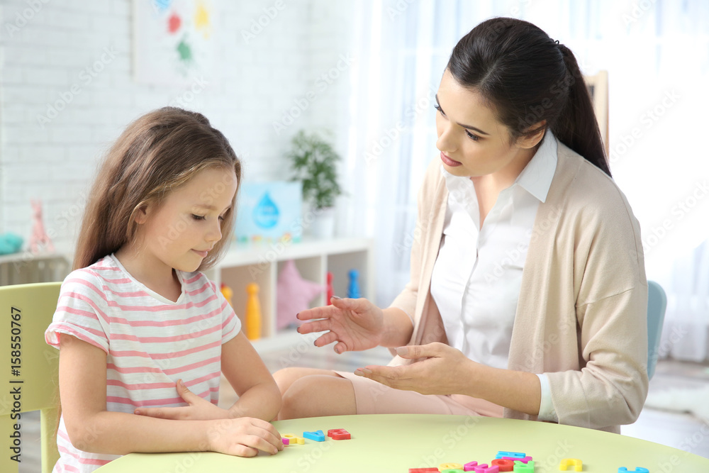 Young woman teacher and little girl on private lesson Young woman teacher and little girl on private lesson