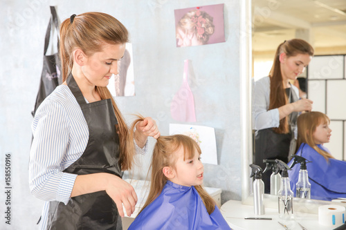 Cute little girl in hairdre...