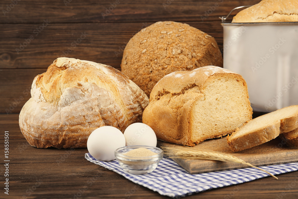 Naklejka premium Different bread and ingredients on wooden table