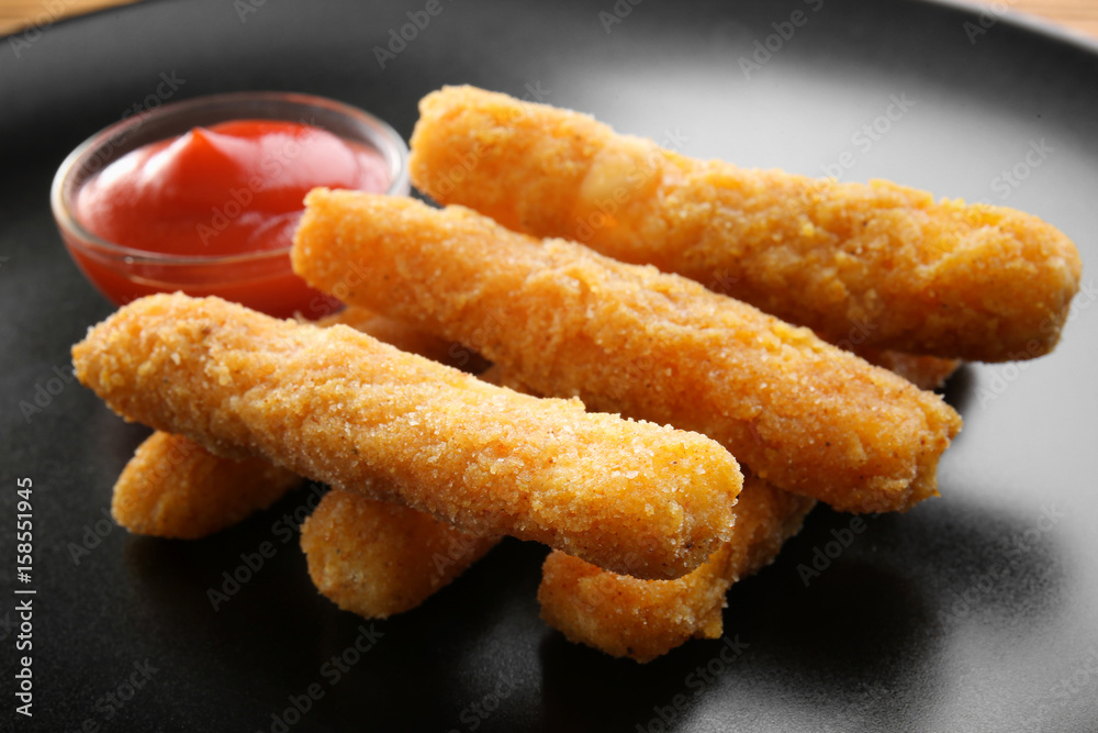 Delicious fried cheese sticks on dark plate Delicious fried cheese sticks on dark plate