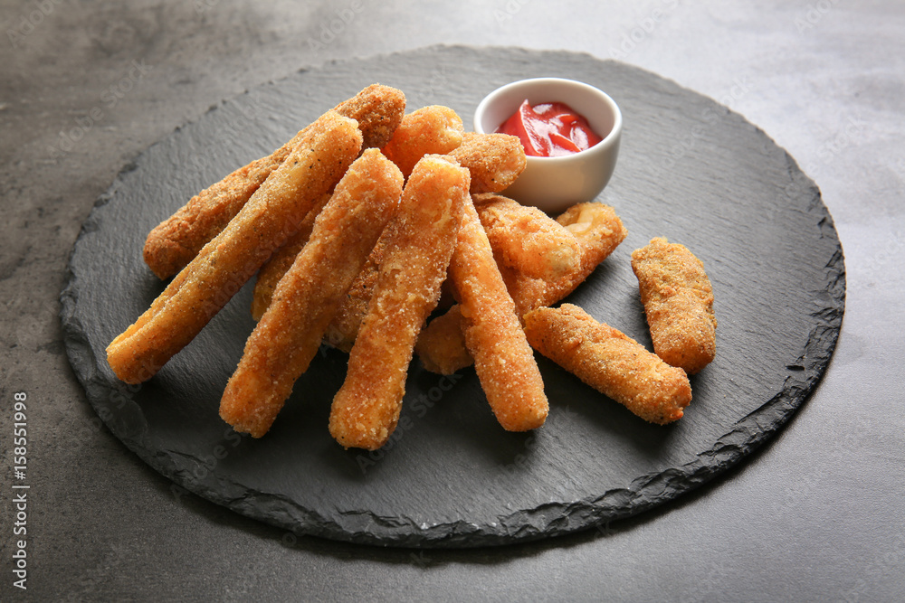 Slate plate with delicious fried cheese sticks