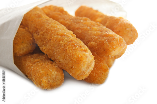 Delicious fried cheese sticks on white background