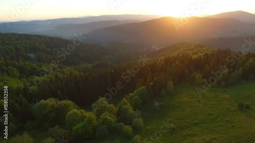 Beautiful aerial view of forest in mountains on sunset