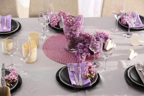 Beautiful table setting decorated with lilac blossom