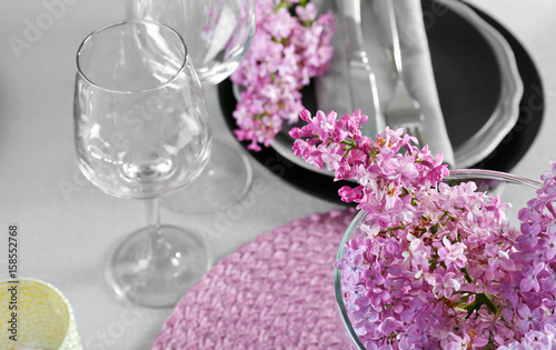 Beautiful lilac bouquet on served table