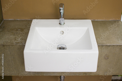 White washbasin with color earth tone of cement