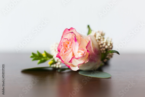 Wedding boutonniere from rose flower and rings