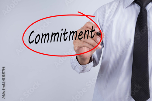 Foto Businessman Hand Writing commitment with a marker over transparent board, Business concept