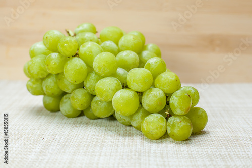 Green grape on brown cloth