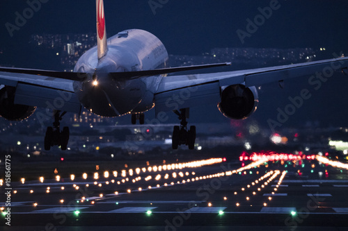 An airplane trying to land at the airport at night