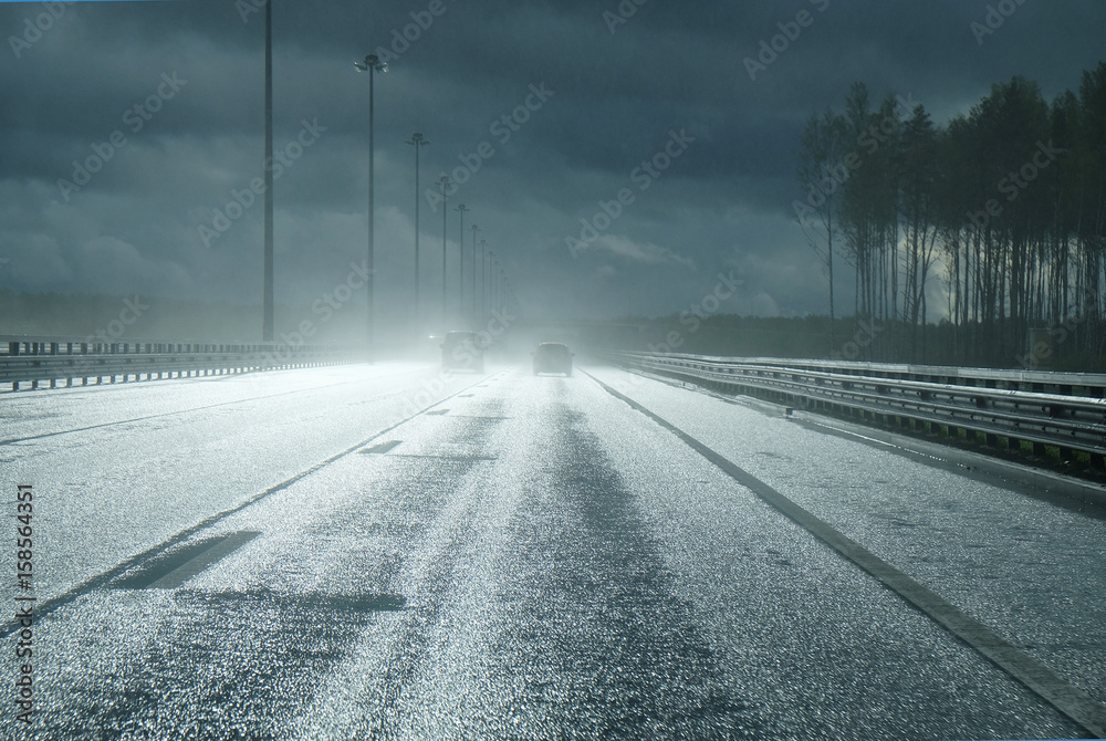 high-speed road after a rain with the falling rays of the sun