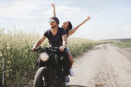 Wallpaper Mural couple in field on motorcycle