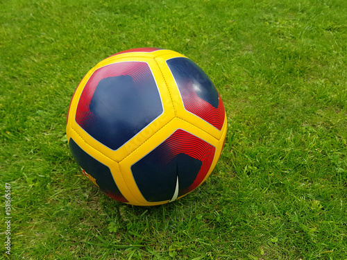 Colorfull soccer ball on a green natural lawn