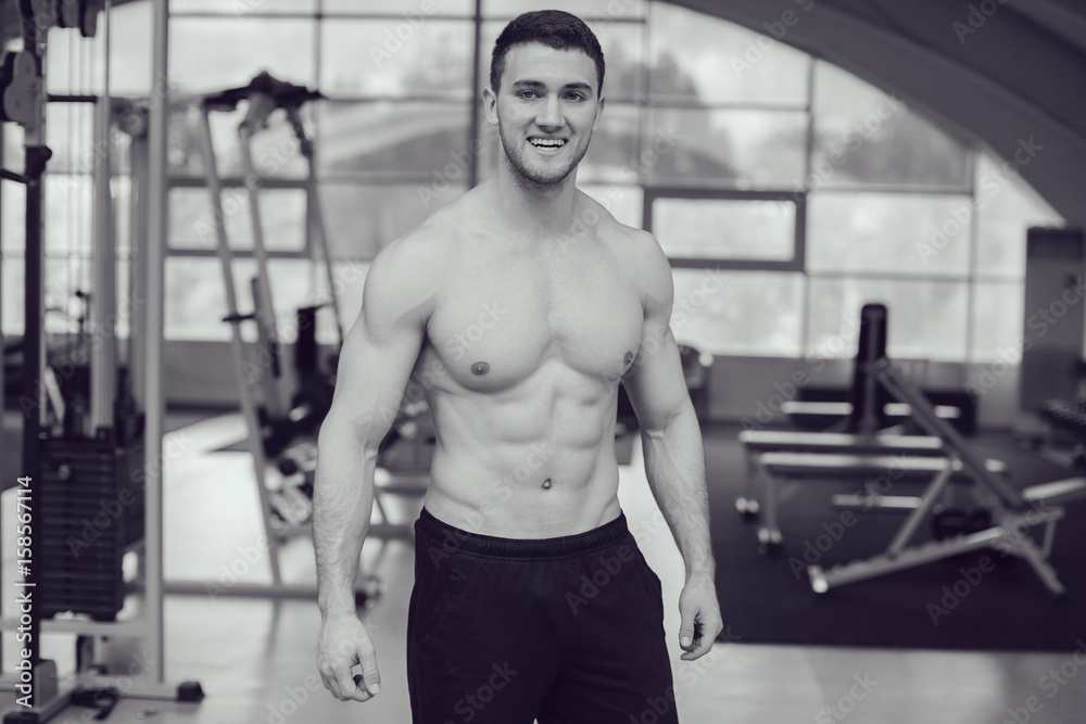 Sexy muscular man in gym working out. Strong male naked torso. Sexy muscular man in gym working out. Strong male naked torso.