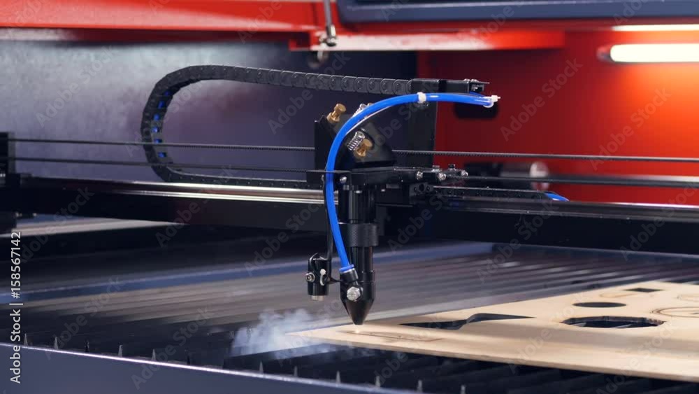 Industrial laser engraver cutting wood.