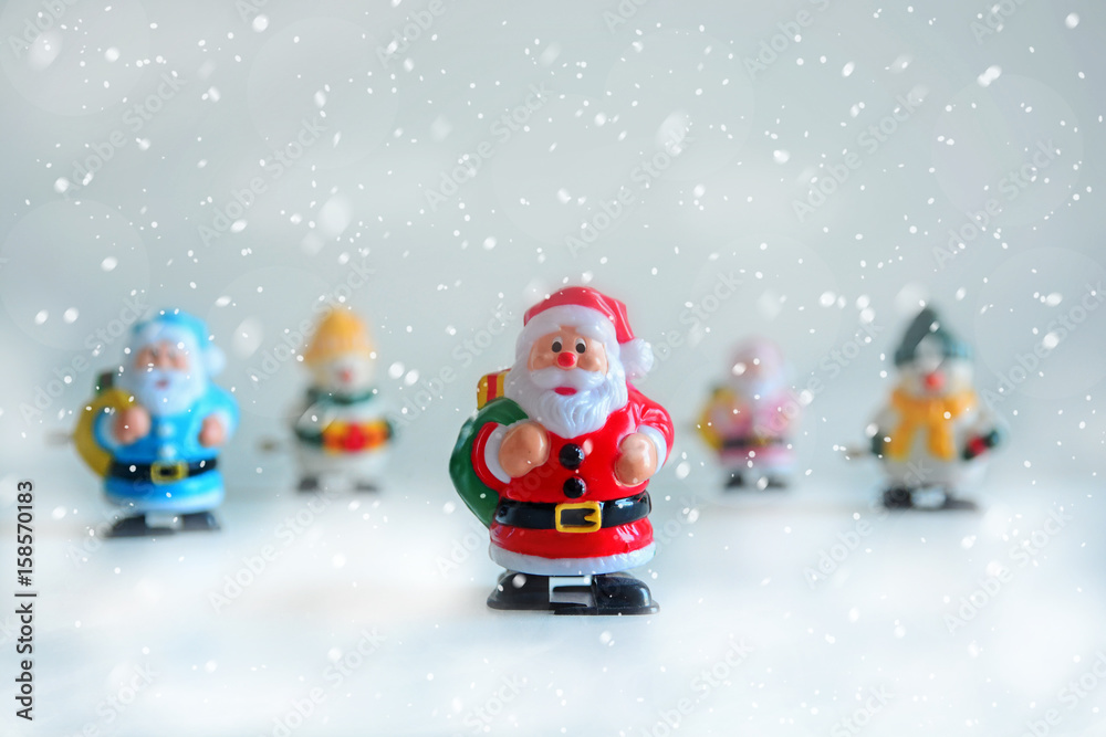 Santa Claus and a snowman holding a gift box in the snow. Santa Claus and a snowman holding a gift box in the snow.