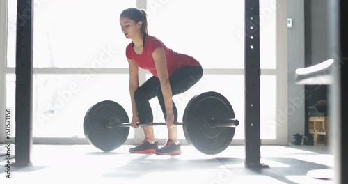 Woman Lifting Barbell Doing Exercise During Workout Training At Gym Natural Light Young Female Athlete Fitness