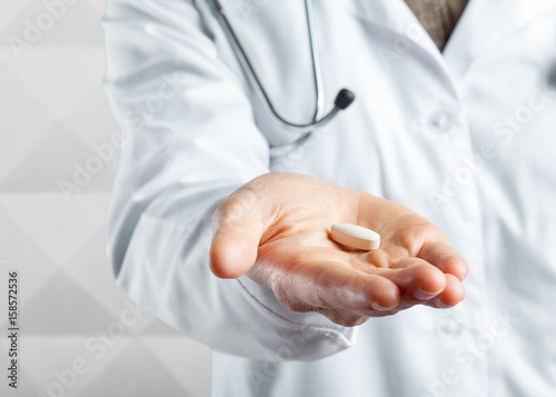 Doctor holding pills