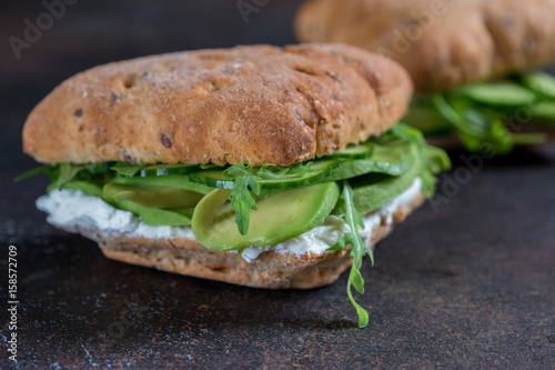 Green sandwich with soft cheese, avocado and fresh cucumber