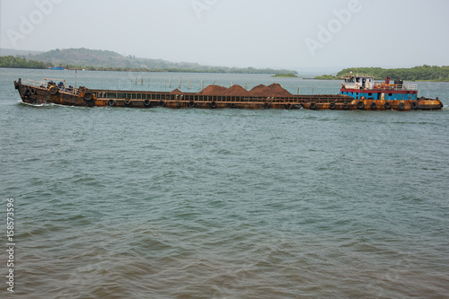 Rusty barge transporting iron ore on the Mandovi River © Vermeulen-Perdaen