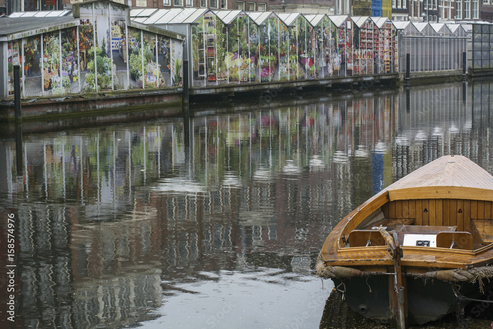 Wooden boat near the flower market in Amsterdam in the Netherlands in the cloudy day