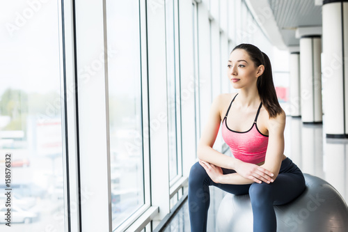 Free Download Beautiful young girl with fit ball. Fitness woman working out with pilates ball, relax and resting after workout - GFXLoad