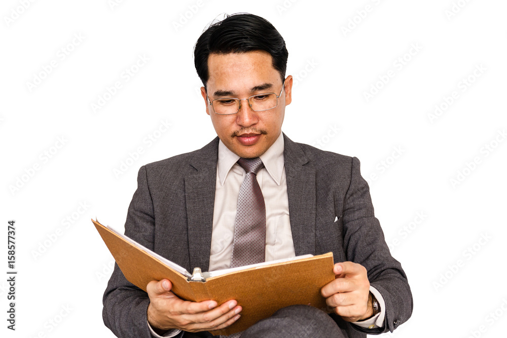 Businessman with hardback book on a white background. Businessman with hardback book on a white background.