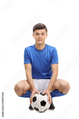 Teenage soccer player with a football