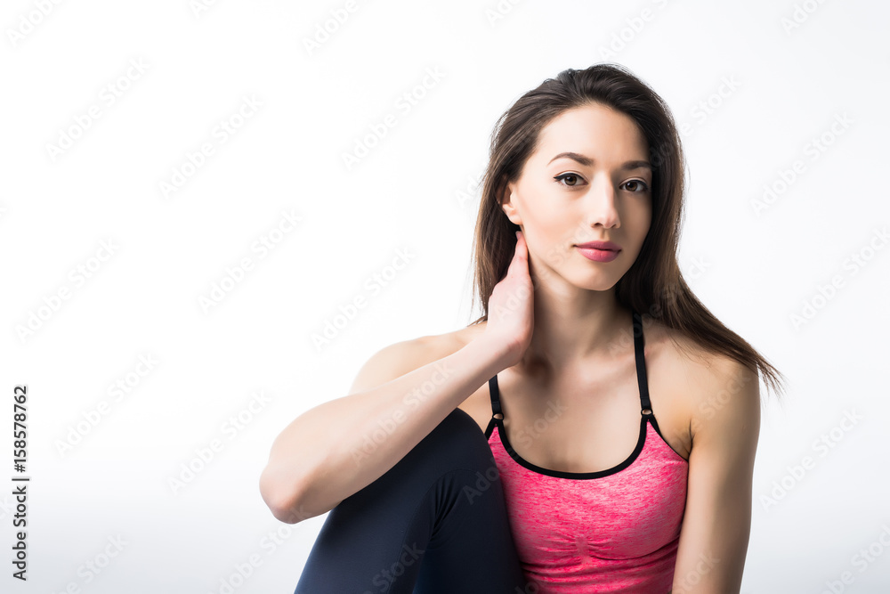 Smiling girl in sport clothes relax after training on a light blue mat. Concept of fitness and active lifestyle. Smiling girl in sport clothes relax after training on a light blue mat. Concept of fitness and active lifestyle.