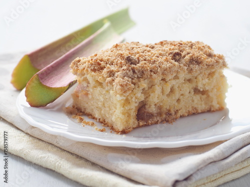 Piece of coffeecake isolated on white. Biscuit with strawberry, rhubarb and apples. Homemade crumble pie with streusel topping. Isolated. Selective focus.