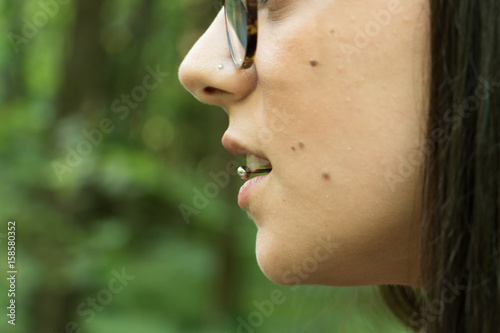 Details of girl with piercing on the tongue