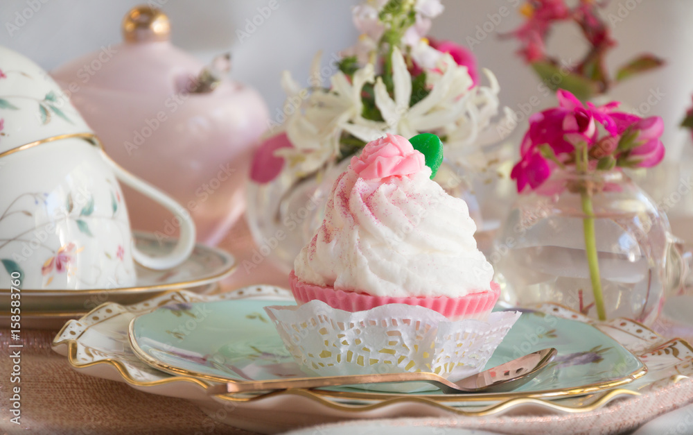 High tea cupcake with pink icing and tea cup