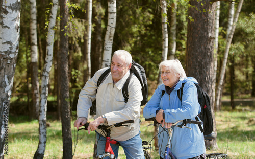 Senior couple riding bikes in nature