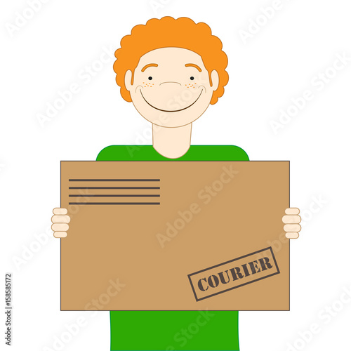 The red-haired cute courier is holding a parcel in his hands. Delivery