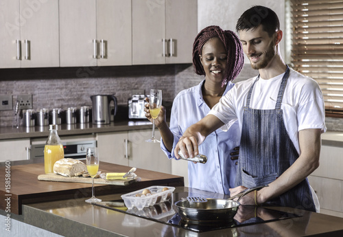 breakfast preparation  kitchen cooking mixed race couple