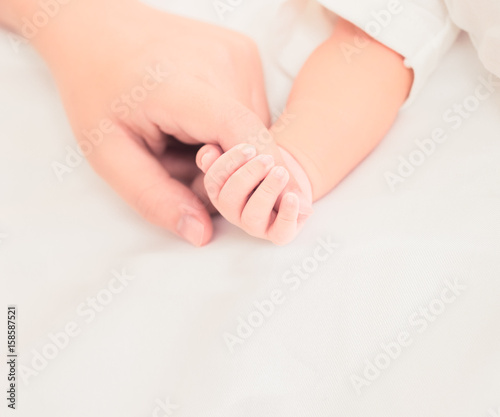 Hand the sleeping baby in the hand of mother close-up (Soft focus and blurry)